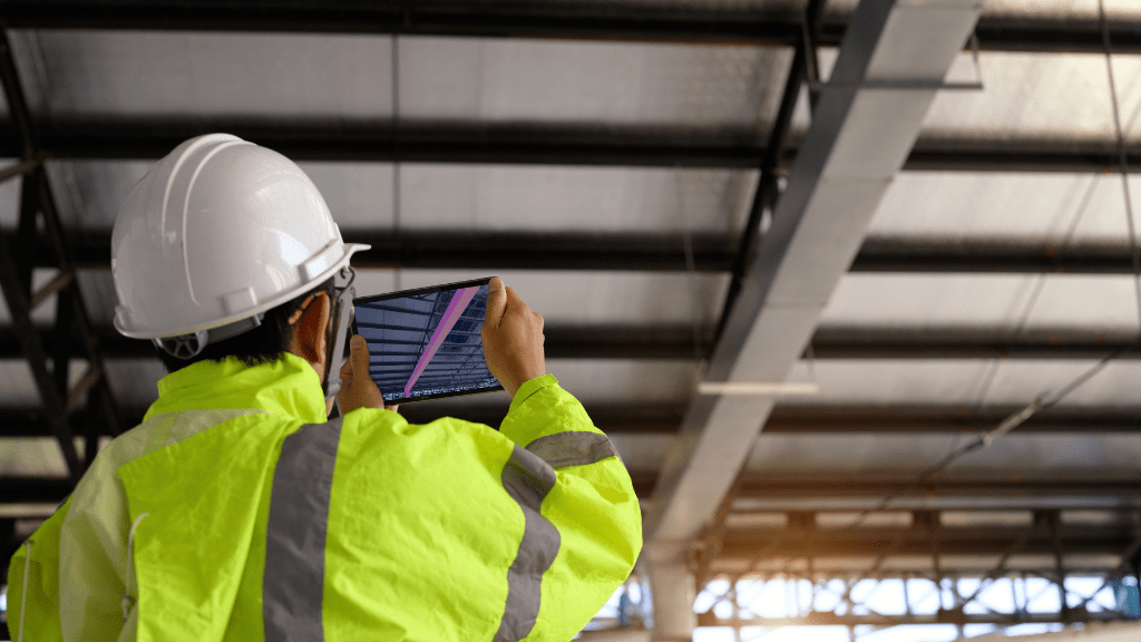 construction manager taking picture with ipad at construction site